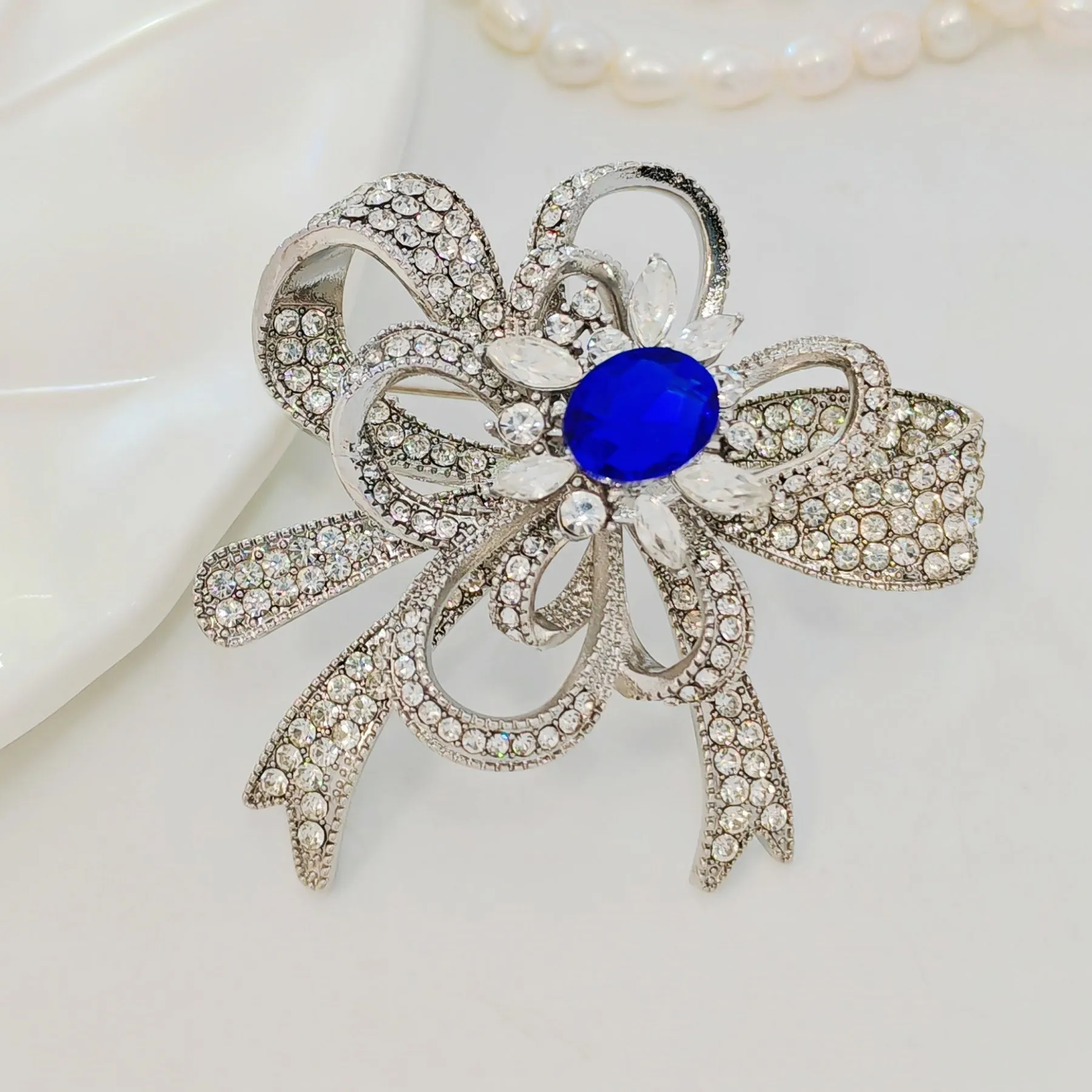 Gorgeous Silver - toned Bow - shaped Brooch with Large Blue Stone and Crystal Embellishments