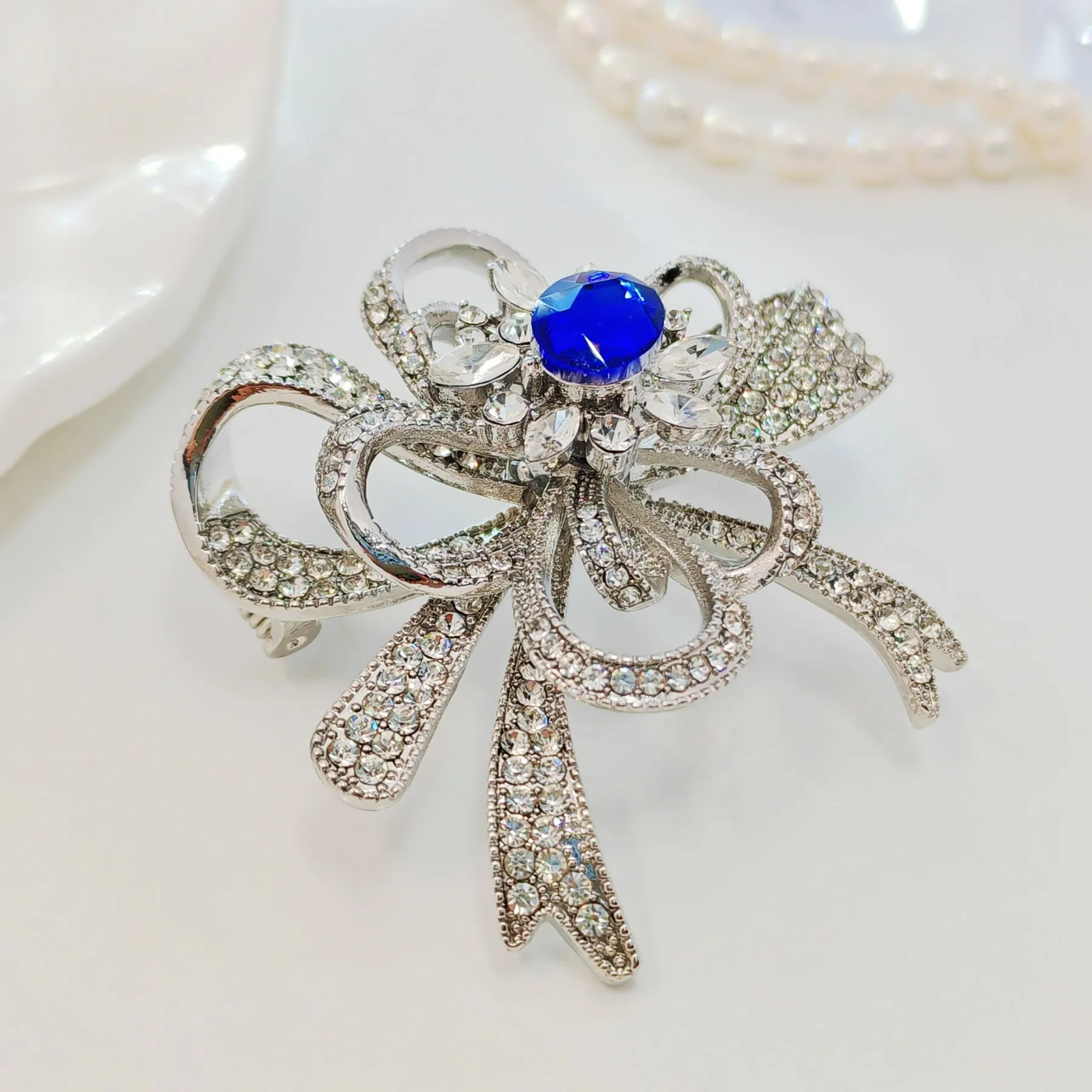 Gorgeous Silver - toned Bow - shaped Brooch with Large Blue Stone and Crystal Embellishments