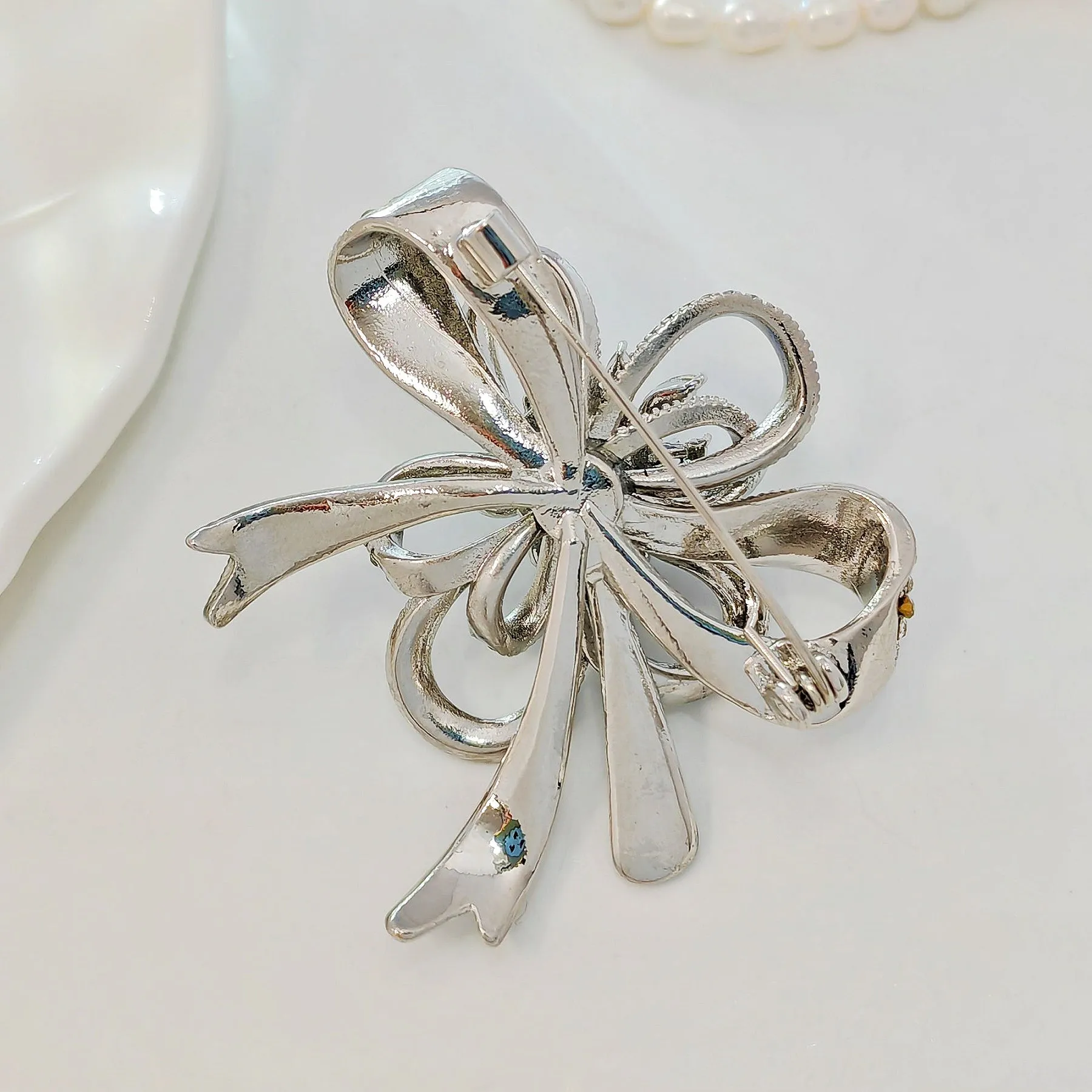 Gorgeous Silver - toned Bow - shaped Brooch with Large Blue Stone and Crystal Embellishments