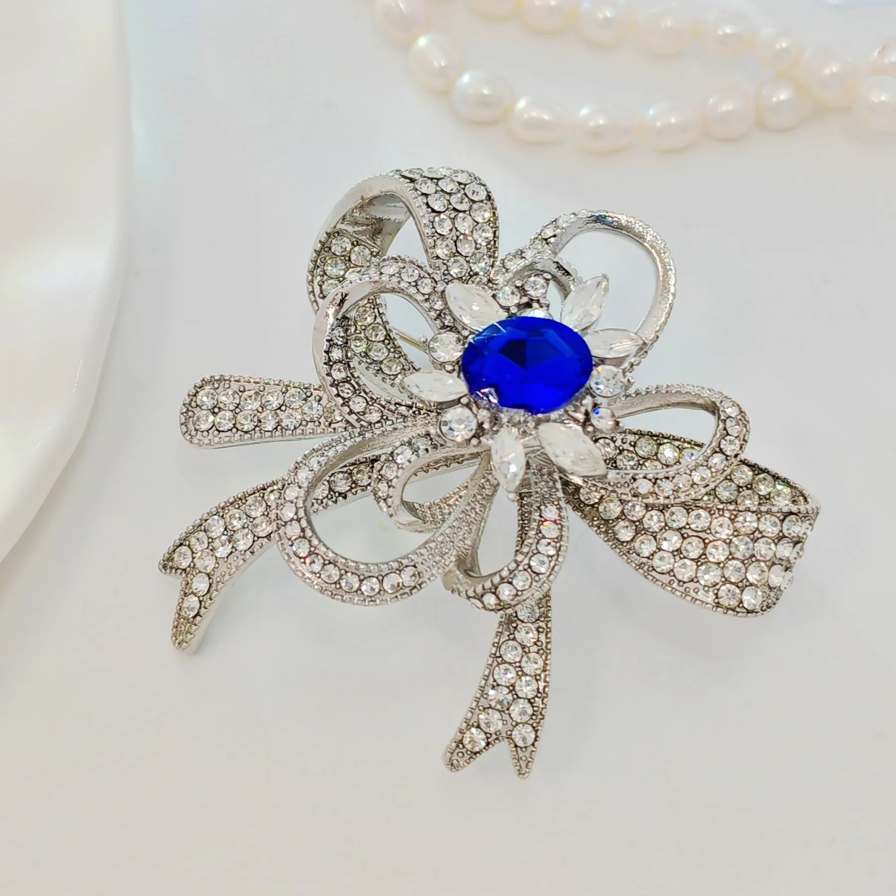 Gorgeous Silver - toned Bow - shaped Brooch with Large Blue Stone and Crystal Embellishments