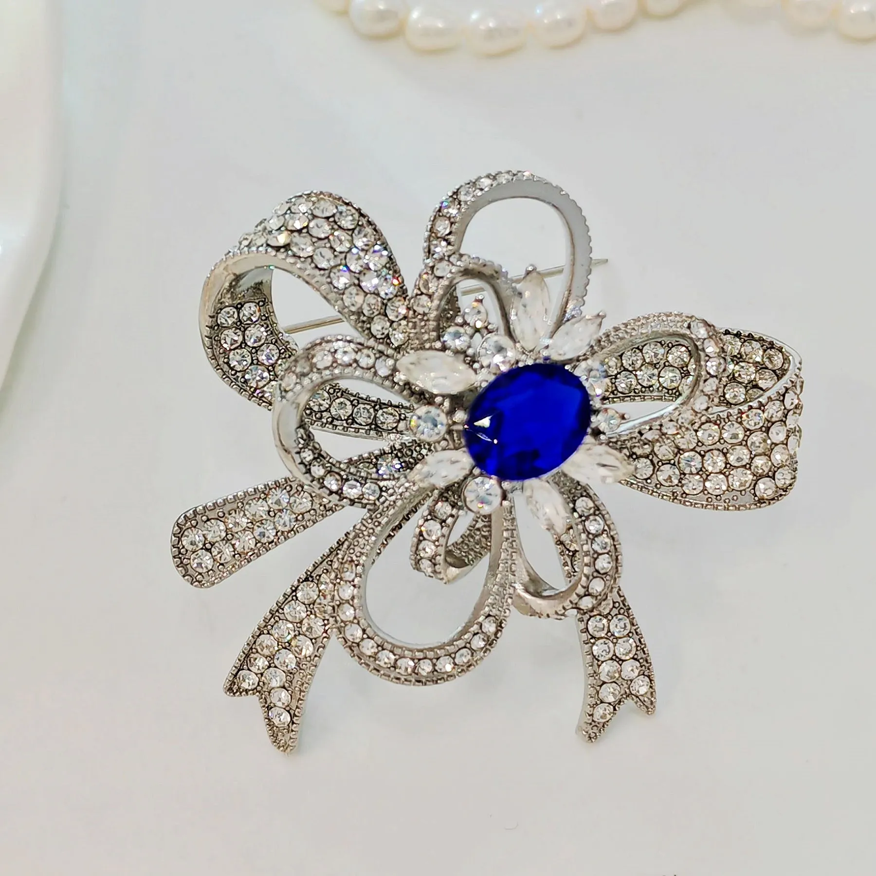 Gorgeous Silver - toned Bow - shaped Brooch with Large Blue Stone and Crystal Embellishments