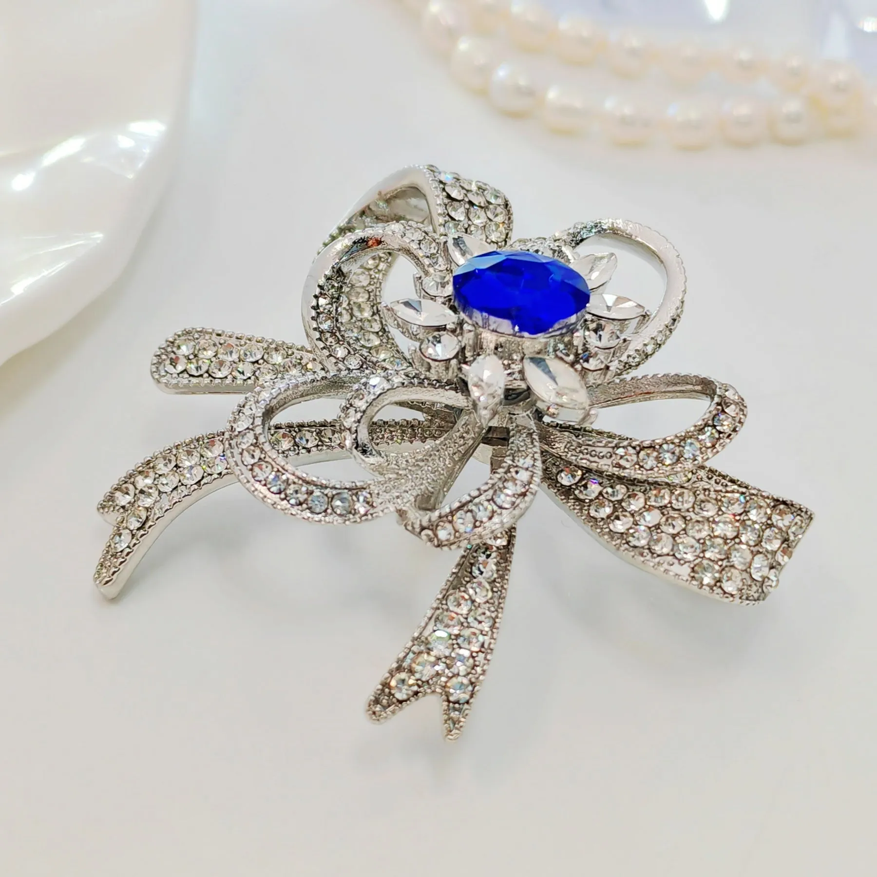Gorgeous Silver - toned Bow - shaped Brooch with Large Blue Stone and Crystal Embellishments