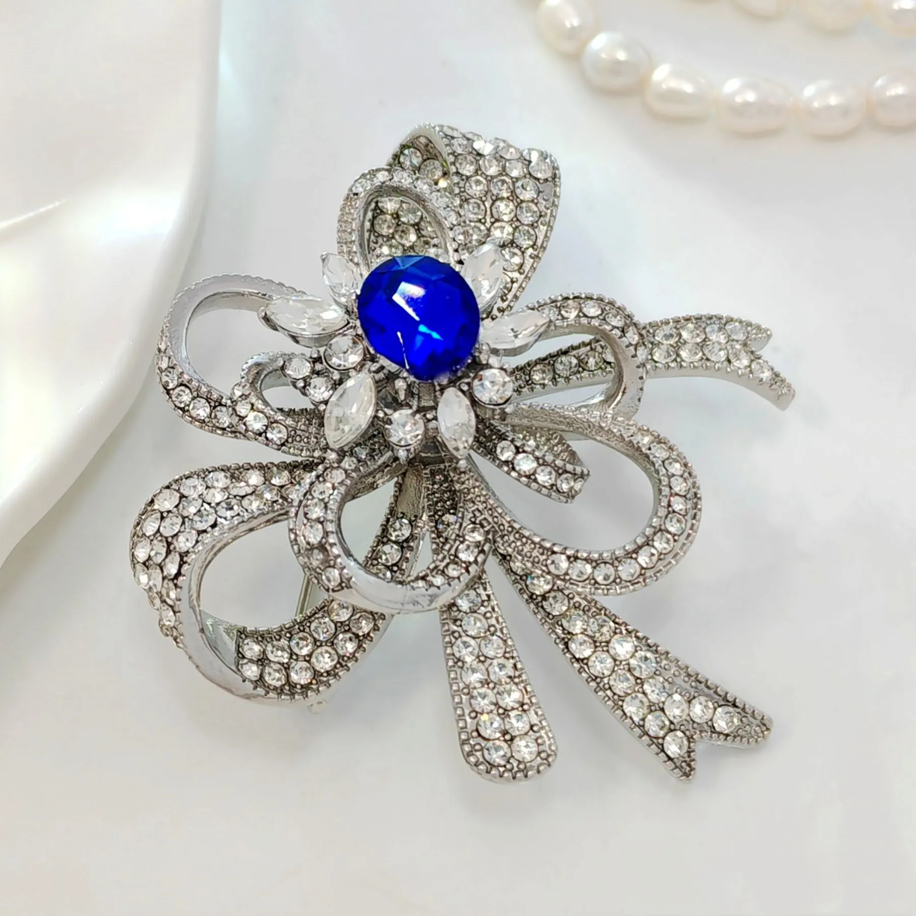 Gorgeous Silver - toned Bow - shaped Brooch with Large Blue Stone and Crystal Embellishments